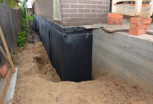 Happy homeowners after waterproofing job in Goddard